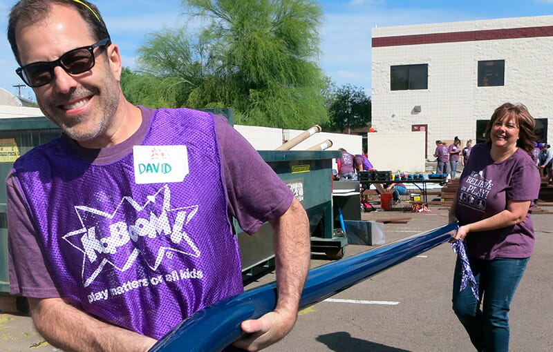 Co-founder David carries playground equipment